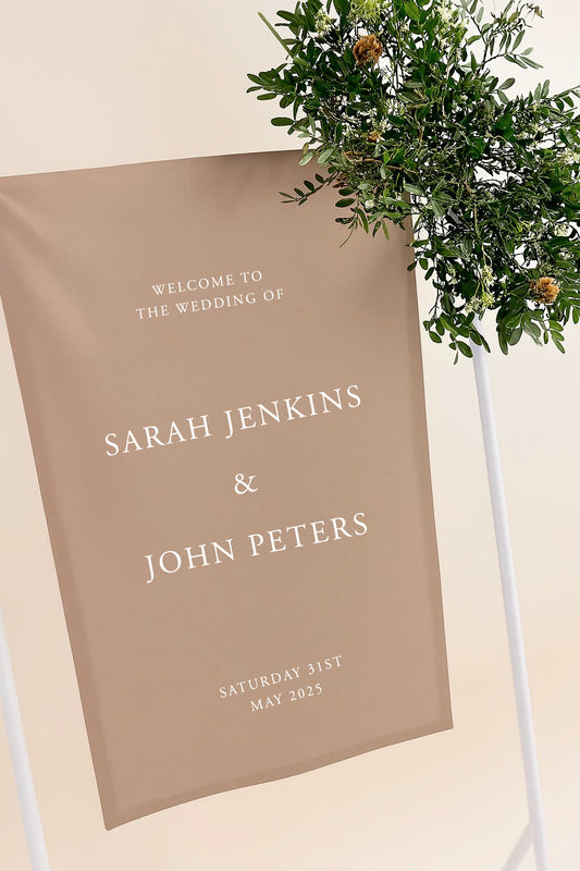 Wedding welcome sign with names and date on a beige background