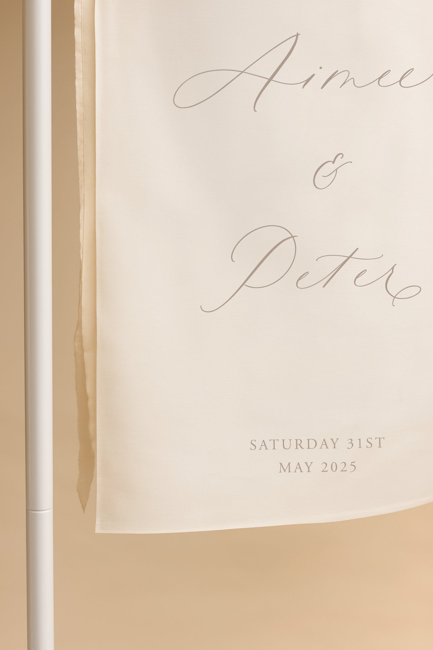 Wedding invitation with names and date on a beige background