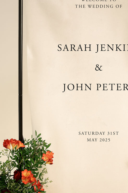 Wedding invitation card with floral design on a beige background