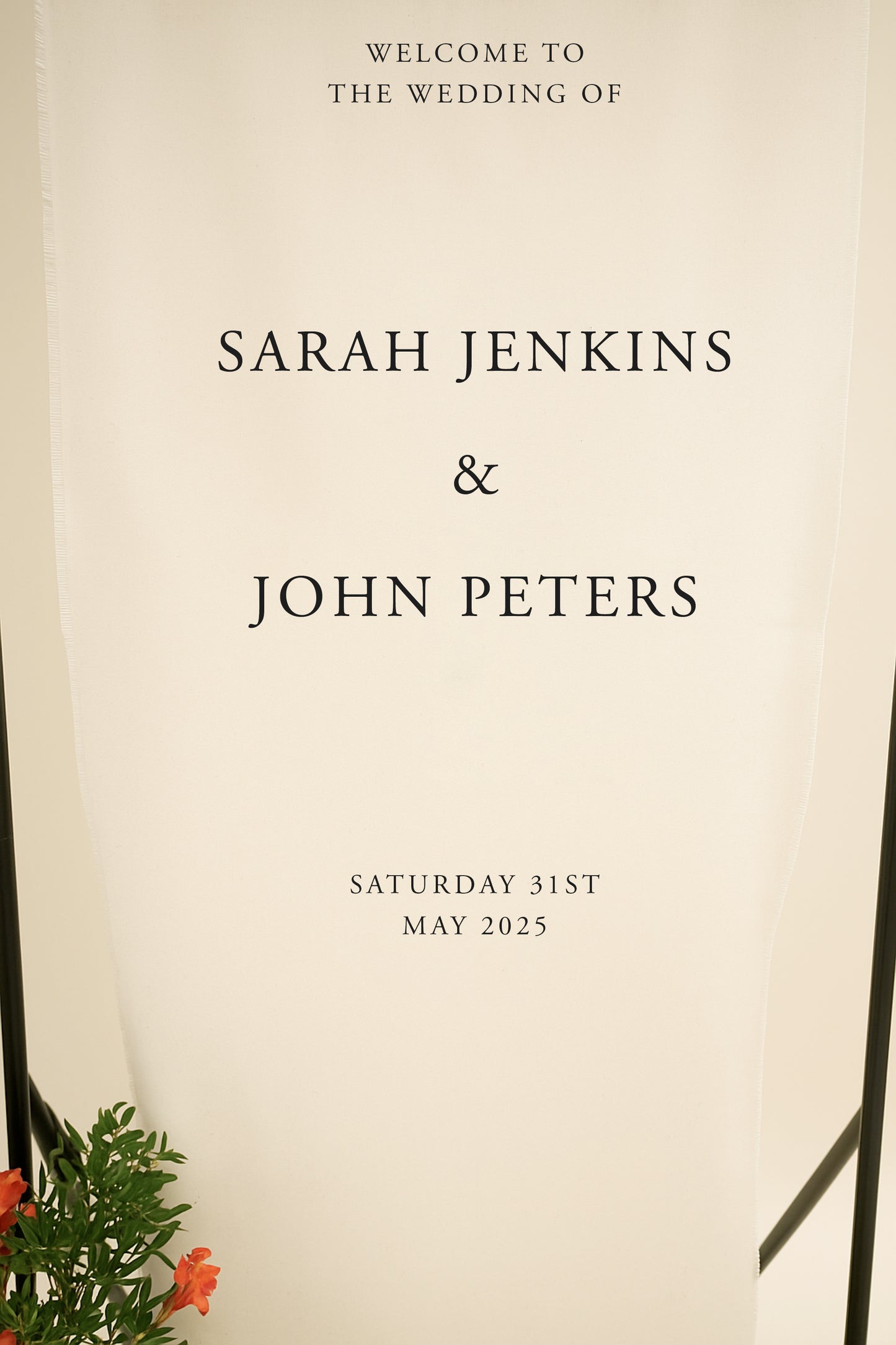 Wedding invitation with text 'Welcome to the wedding of Sarah Jenkins & John Peters' on a beige background.