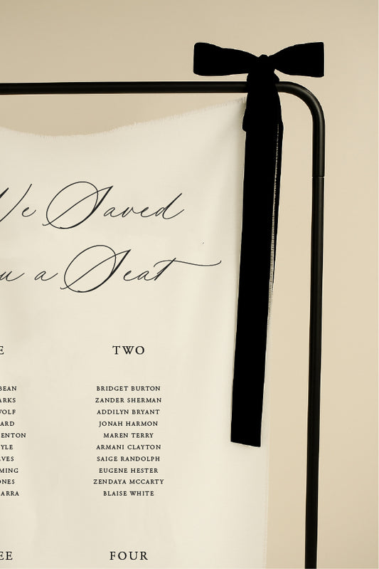 Book with a black ribbon on a beige background