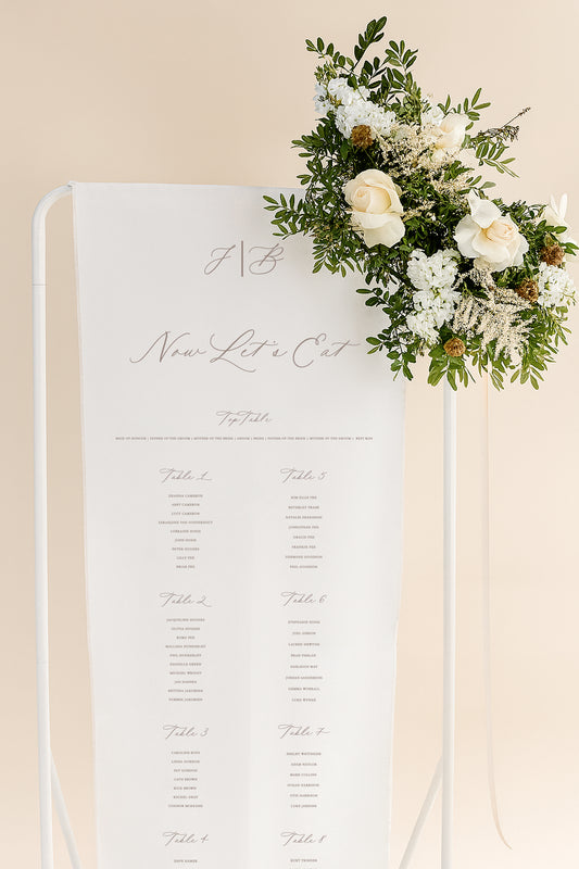 Table seating chart with floral decoration on a beige background