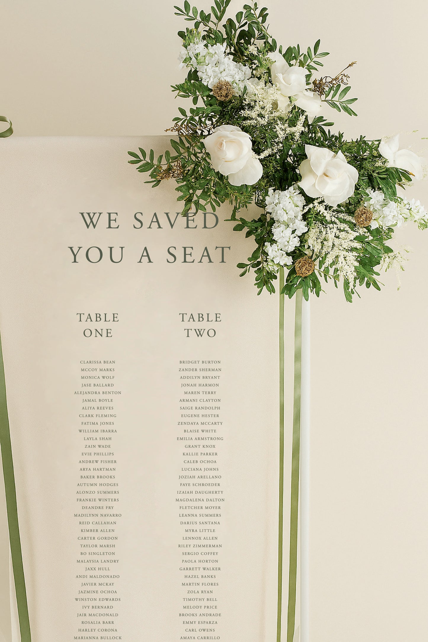 Wedding seating chart with floral decoration on a beige background