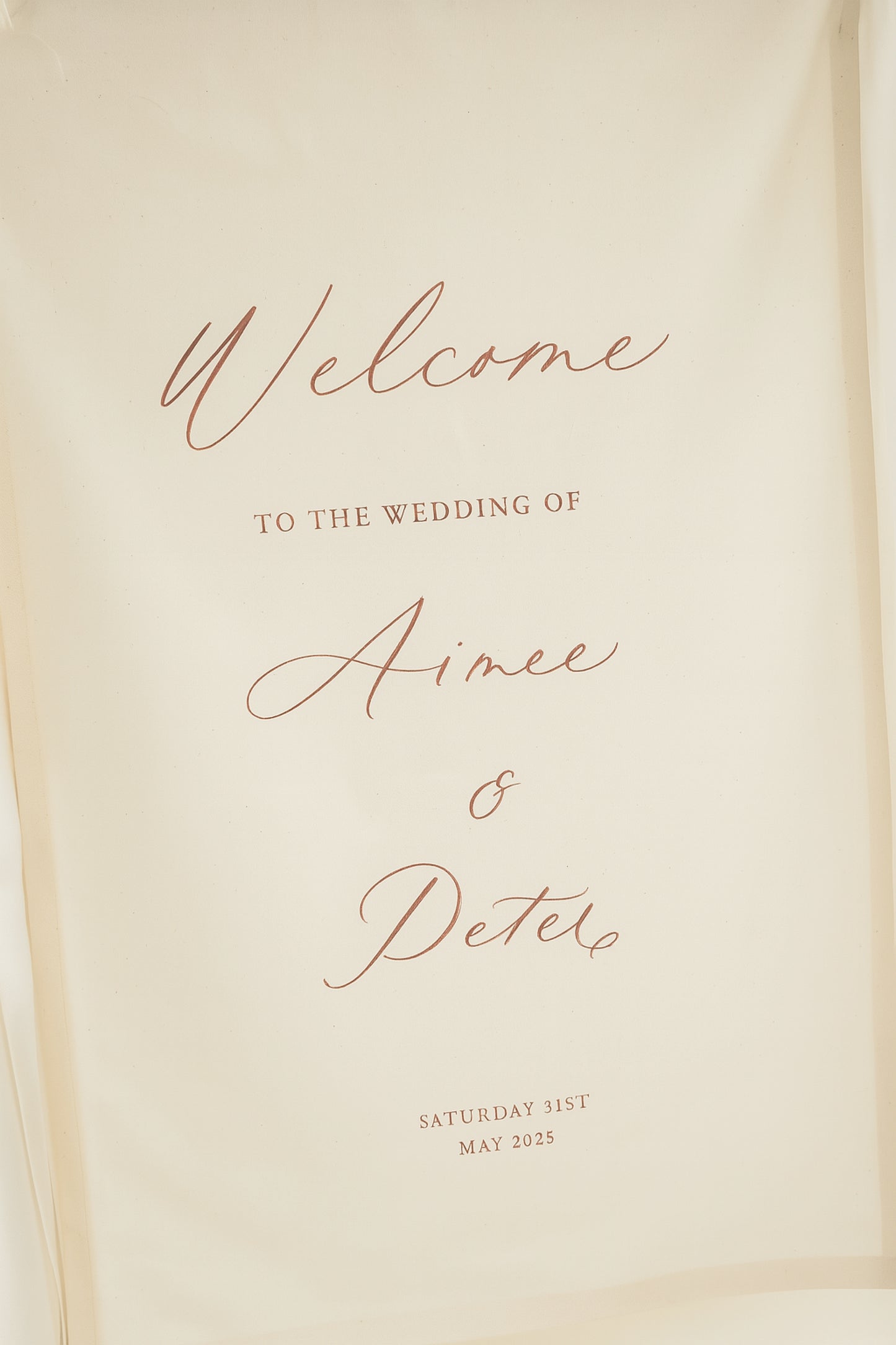 Welcome sign for Aimee and Peter's wedding on a beige background