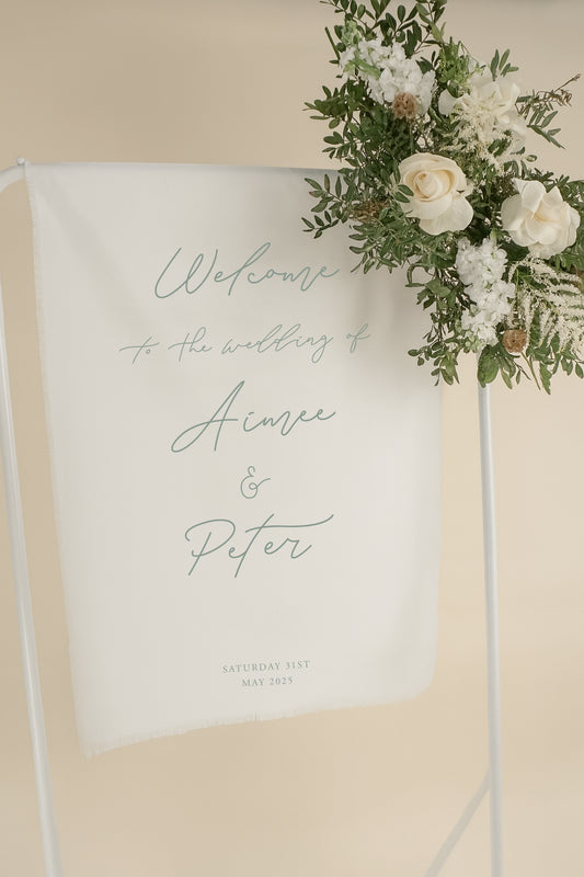 Wedding welcome sign with floral decorations on a beige background