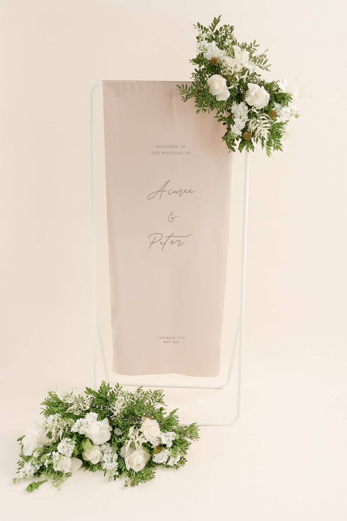Wedding welcome sign with floral decorations on a beige background
