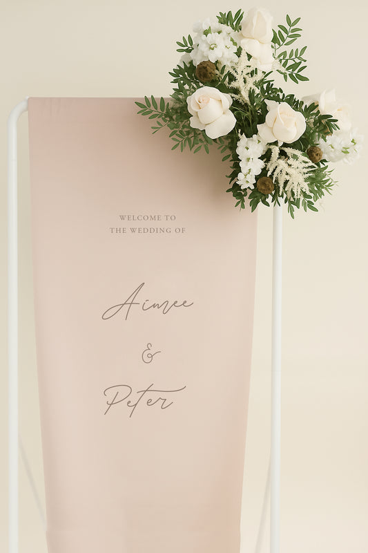 Decorative wedding sign with floral arrangement on a beige background