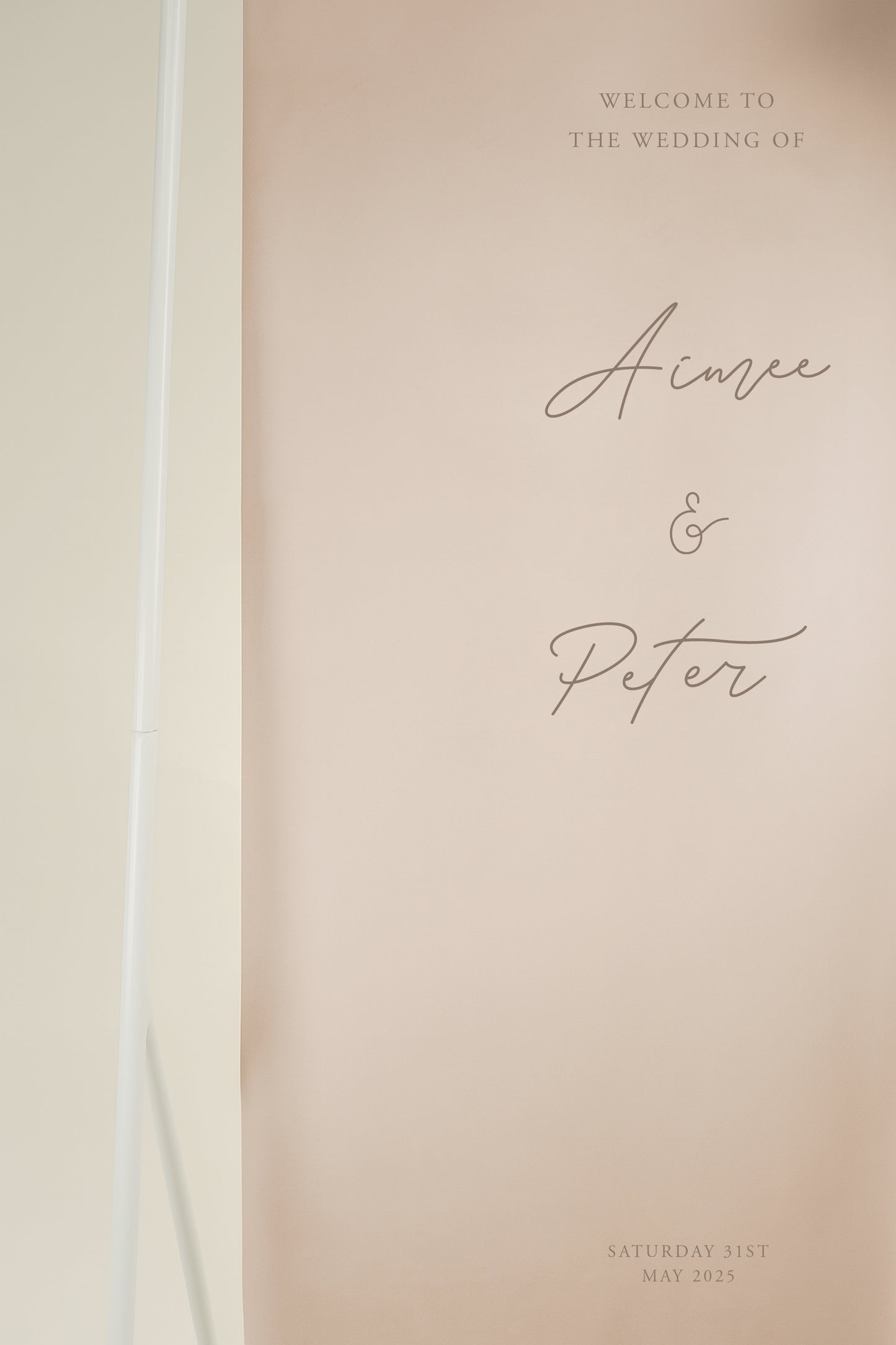 Wedding welcome sign with script font name on a beige background