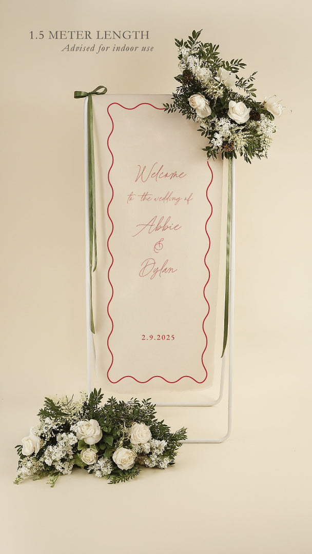 Wedding welcome sign with floral decorations on a beige background