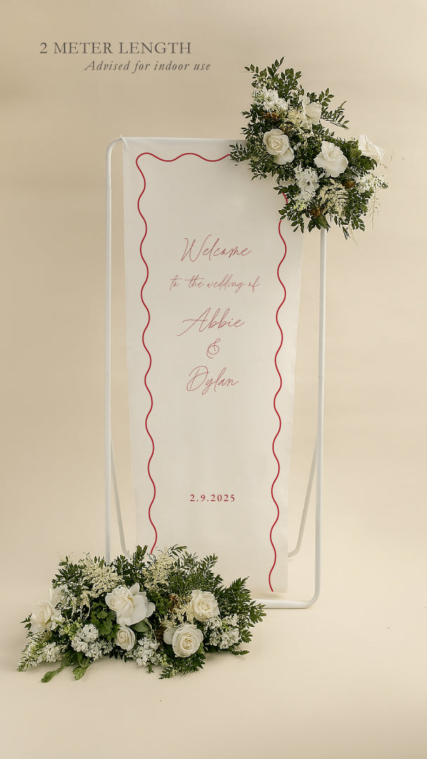 Wedding welcome sign with floral decorations on a beige background