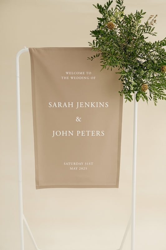 Wedding welcome sign with names and date on a beige background