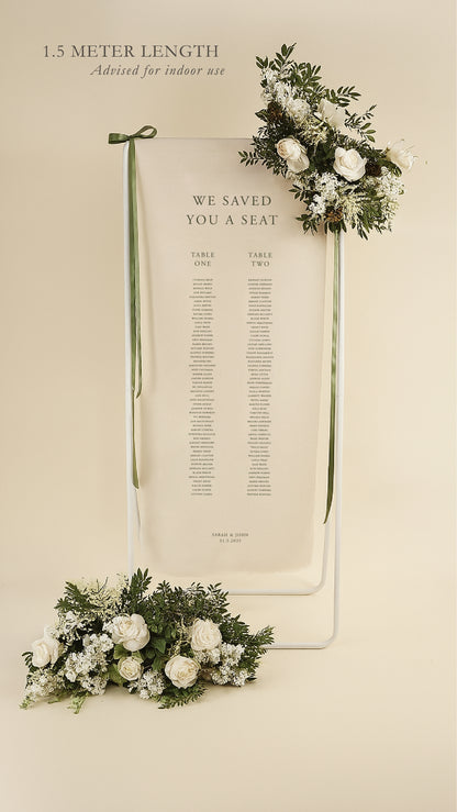 Wedding seating chart with floral decorations on a beige background