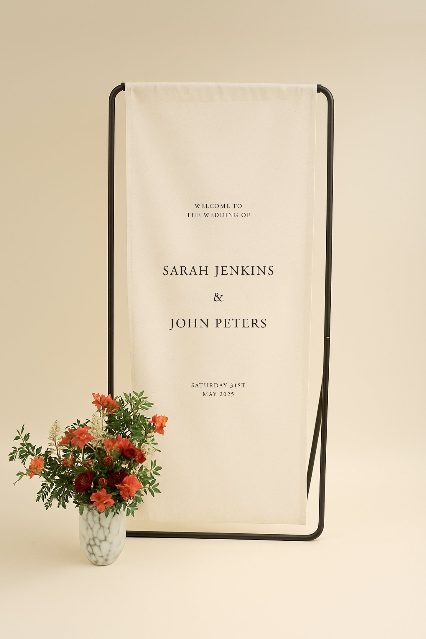 Wedding welcome sign with floral arrangement on a beige background