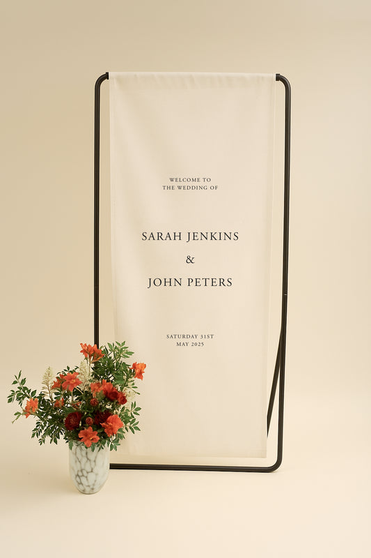 Wedding welcome sign with floral arrangement on a beige background
