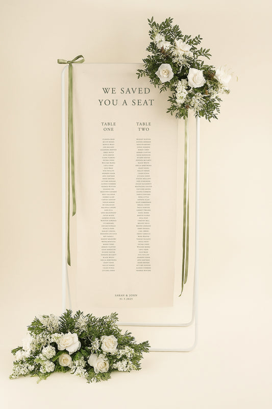 Wedding seating chart with floral decorations on a beige background