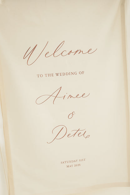 Welcome sign for Aimee and Peter's wedding on a beige background