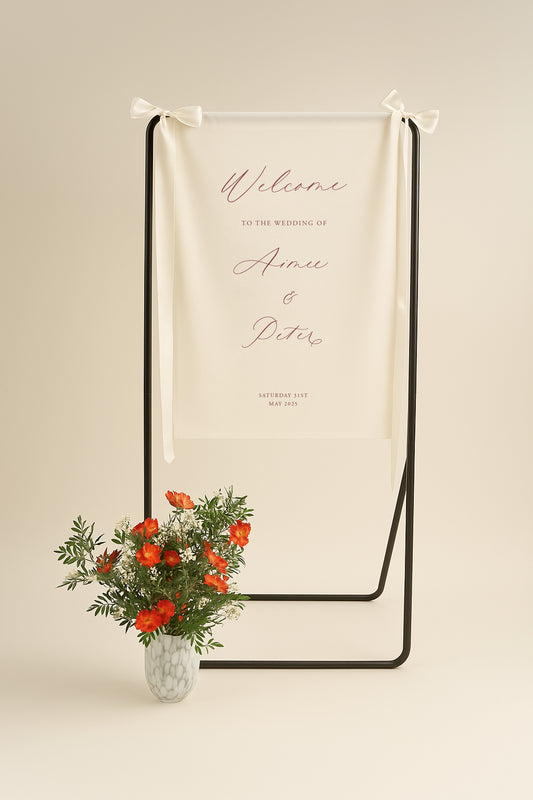 Wedding welcome sign with floral arrangement on a beige background