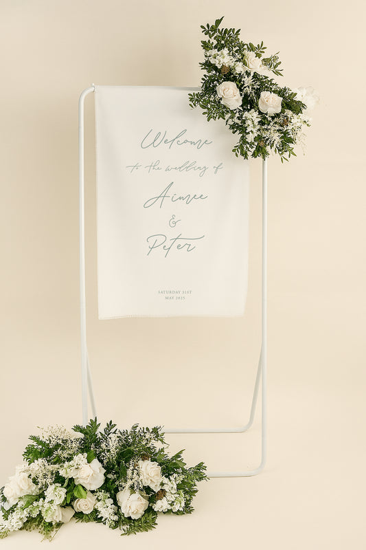 Wedding welcome sign with floral decorations on a beige background
