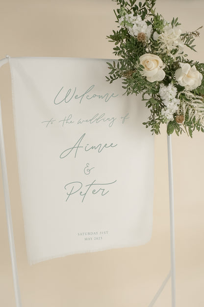 Wedding welcome sign with floral decorations on a beige background