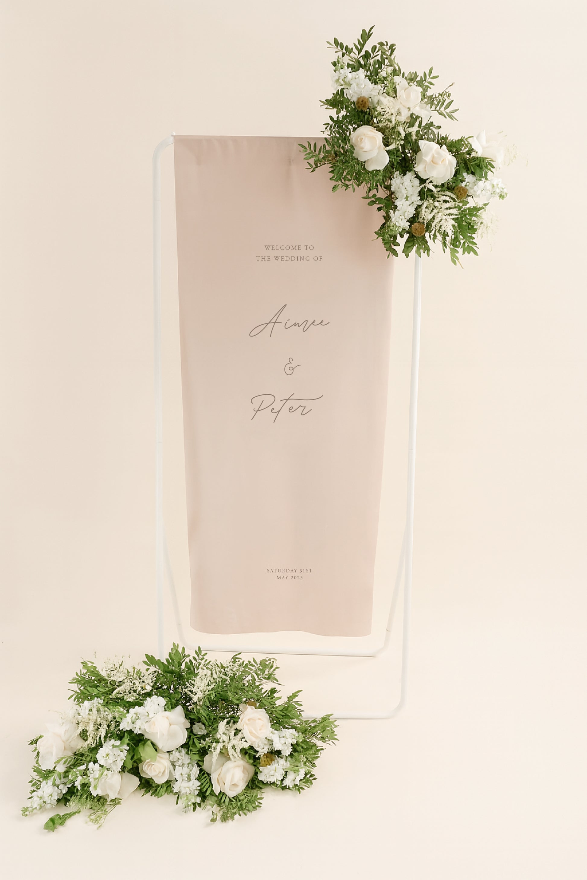 Wedding welcome sign with floral decorations on a beige background