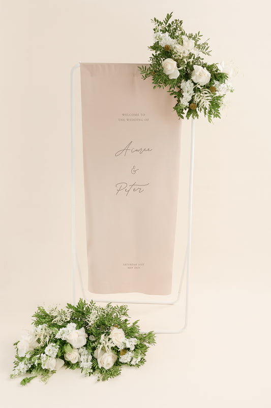 Wedding welcome sign with floral decorations on a beige background