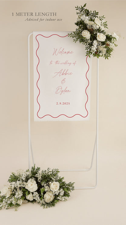 Wedding welcome sign with floral decorations on a beige background